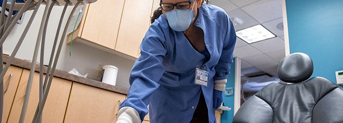 Environmental Services Technician cleaning dental equipment